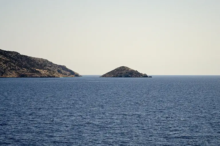 The open deck of a ferry crossing the Aegean, with the sea behind.
