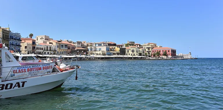 The waterfront houses of the old harbor of Chania, Crete, seen from the water.