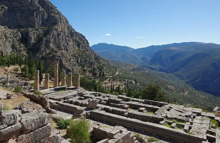 The columns of the Temple of Apollo at Delphi, above the valley that runs down toward the Gulf of Corinth.