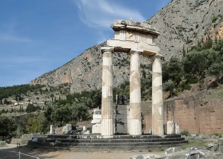 The three standing columns of the Tholos at Delphi, with the slopes of Parnassus behind.