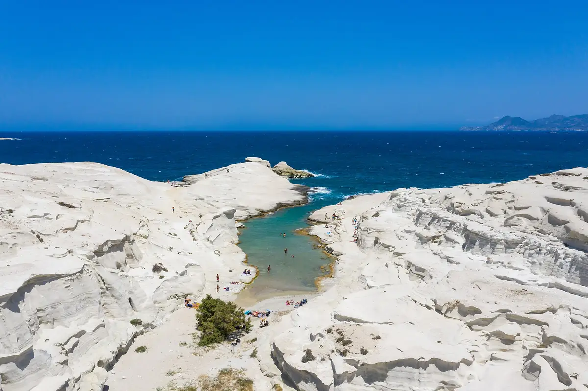 The white volcanic rock of Sarakiniko on Milos, seen from above, with the sea beyond.
