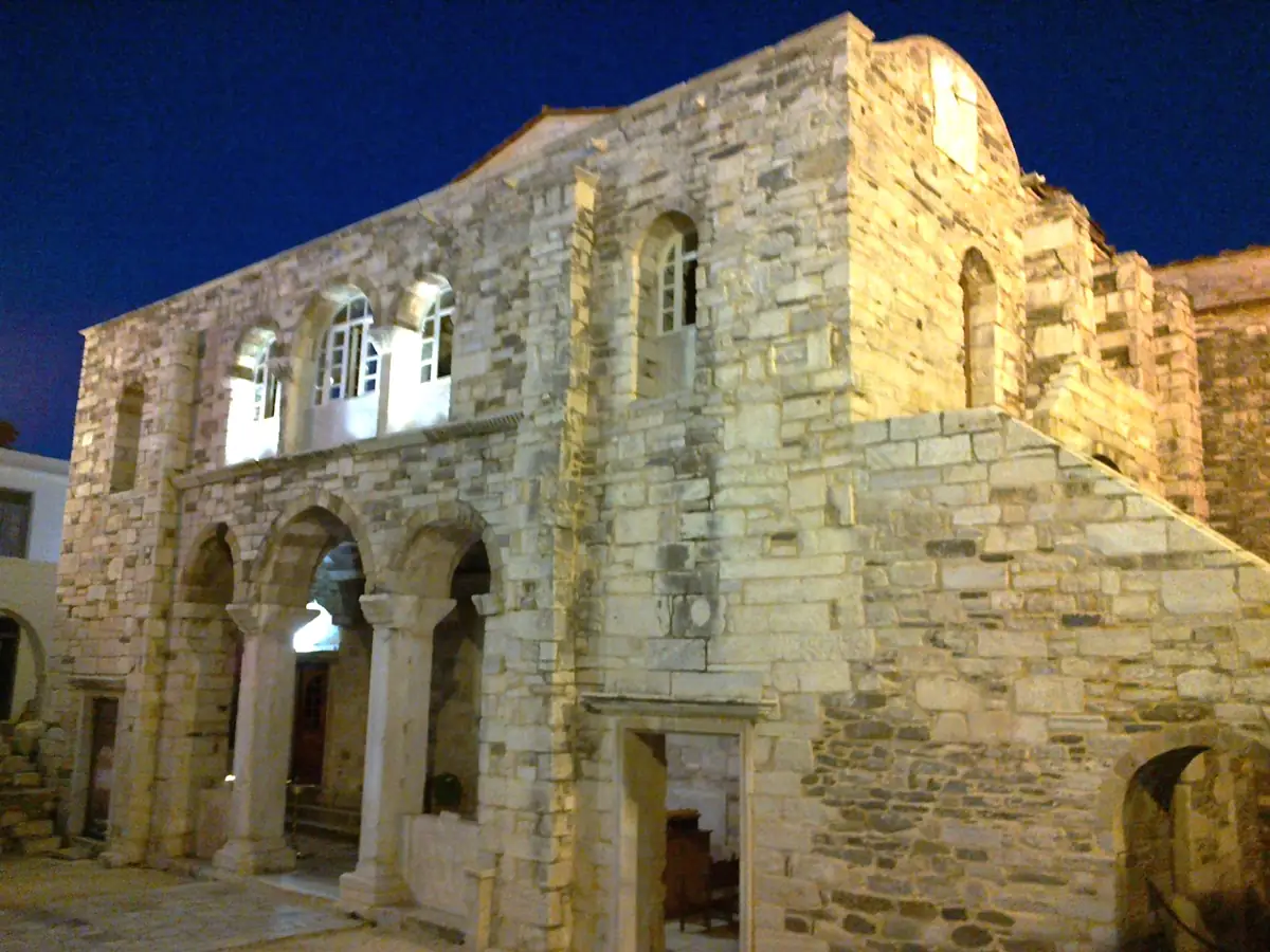The stone front of Panagia Ekatontapiliani, the church of a hundred doors, in Parikia, Paros, at dusk.