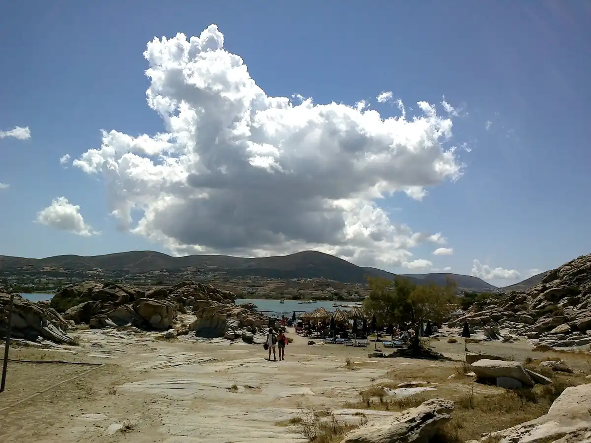 The bay of Naoussa seen from the rocks of Kolymbithres, Paros, under summer clouds.