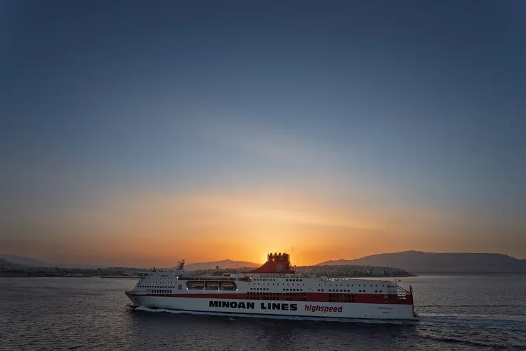 A ferry leaving the port of Piraeus at sunset.