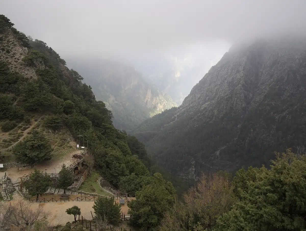 The Samaria gorge in western Crete seen from above, with mist on the mountains.