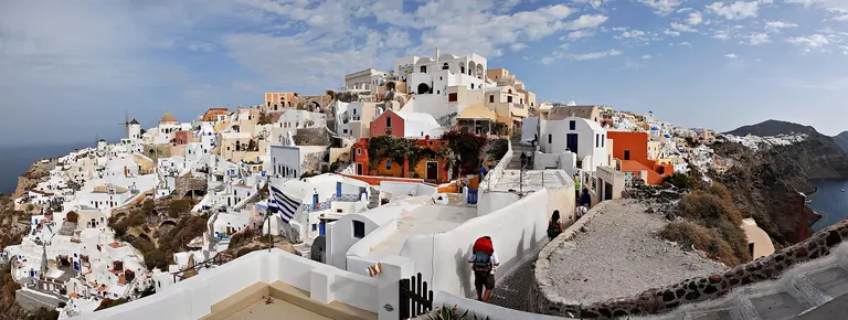 The white houses of Oia, Santorini, stepped down the rim of the caldera.