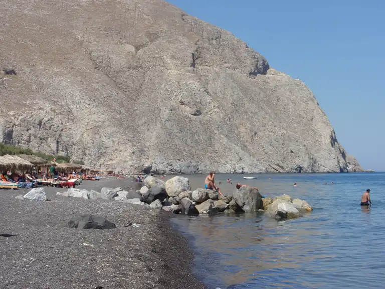 The black-sand beach of Perissa, Santorini, below the cliff of Mesa Vouno.